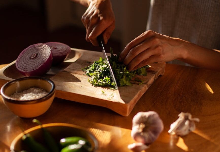 a woman chopping cilantro