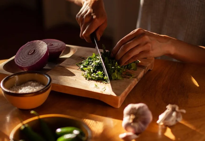a woman chopping cilantro