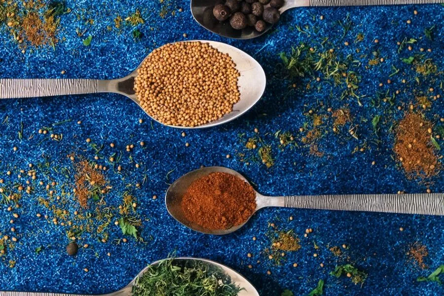 variety of spices on spoons found in Belizean Ingredients