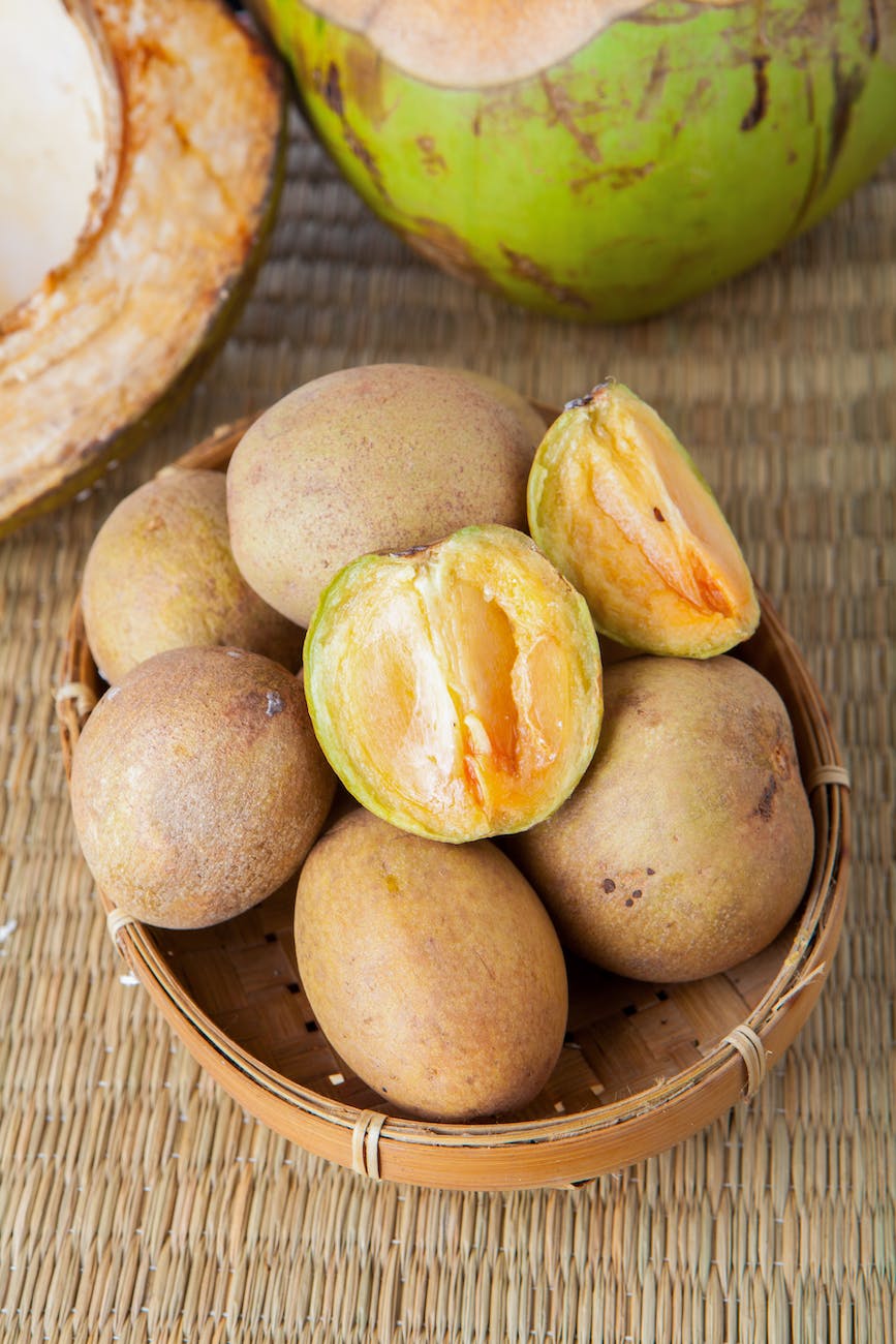 brown round fruit on brown woven basket