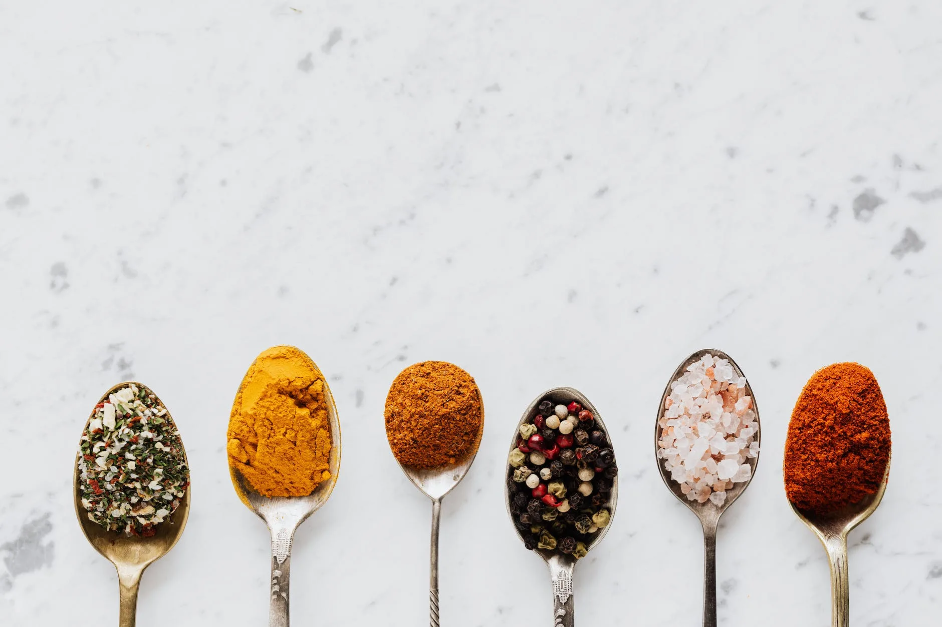 composition of spoonfuls with various Belizean spices