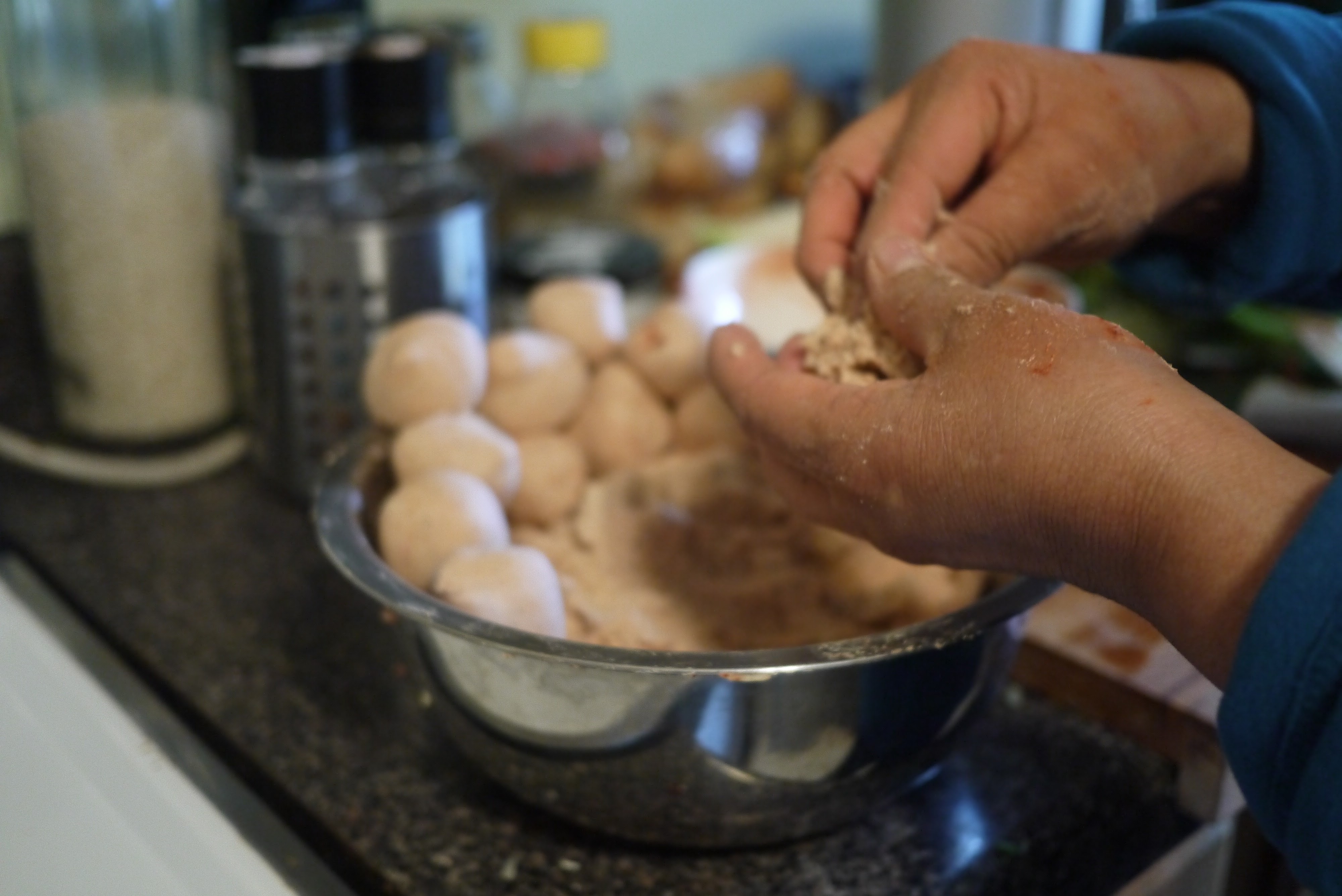 pinching and smoothing masa ball for Belizean corn tortilla