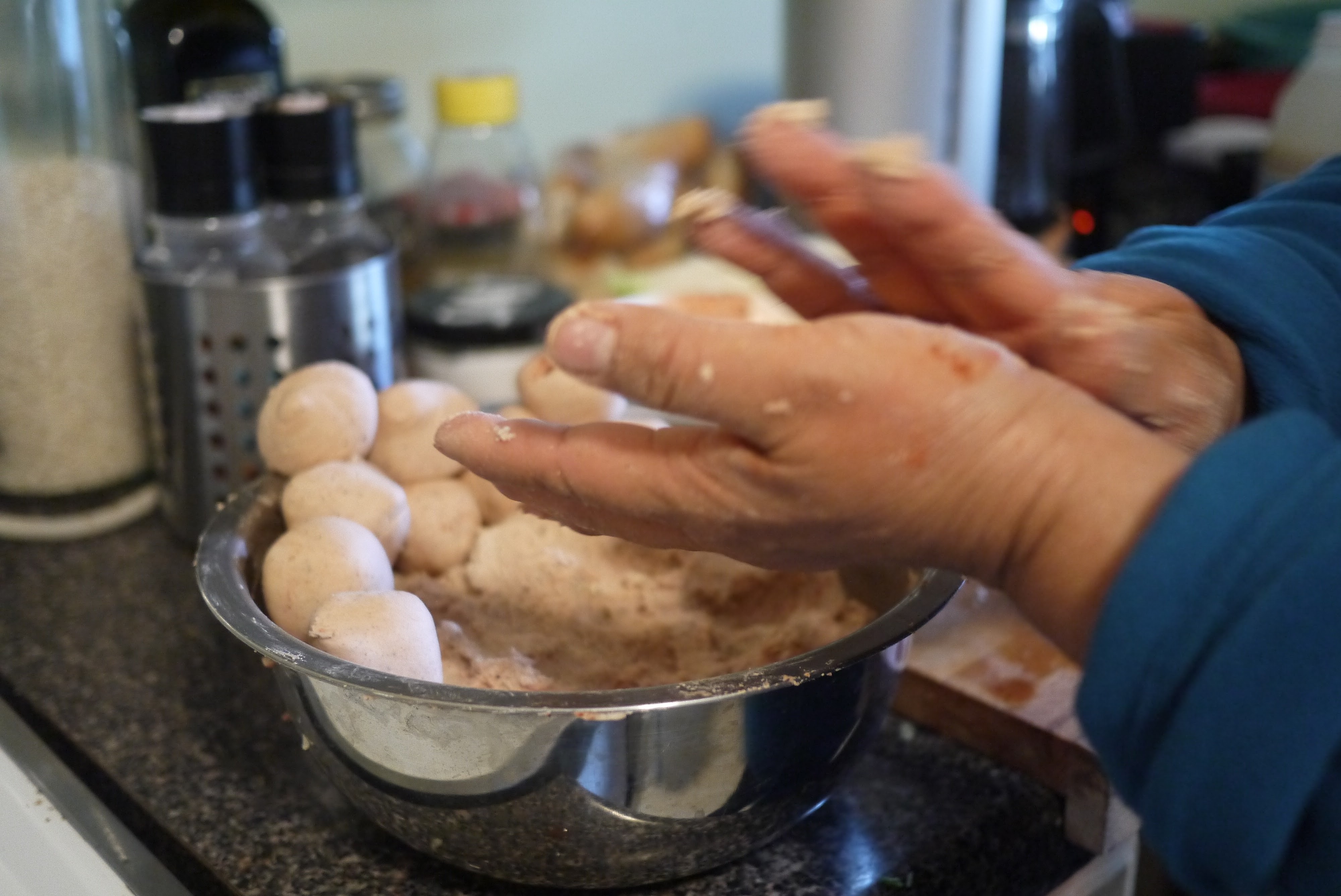 portioning next masa ball for corn tortilla from bowl