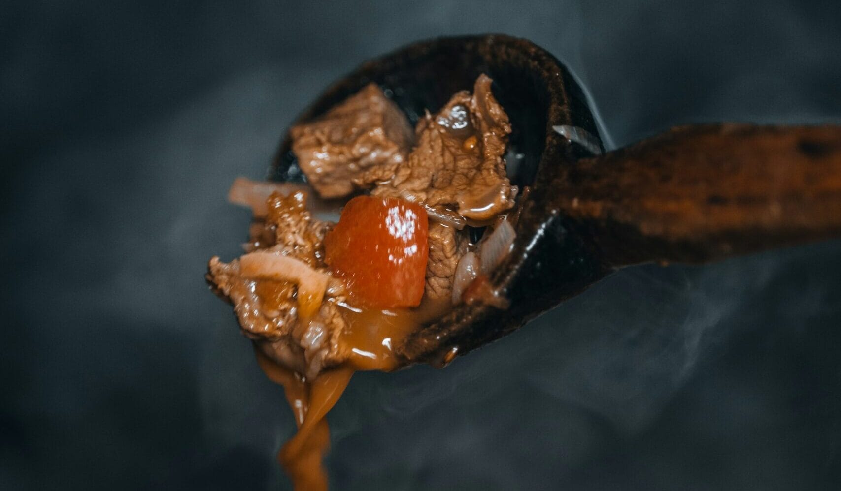 chocolomo recipe steaming meat and broth on ladle belize