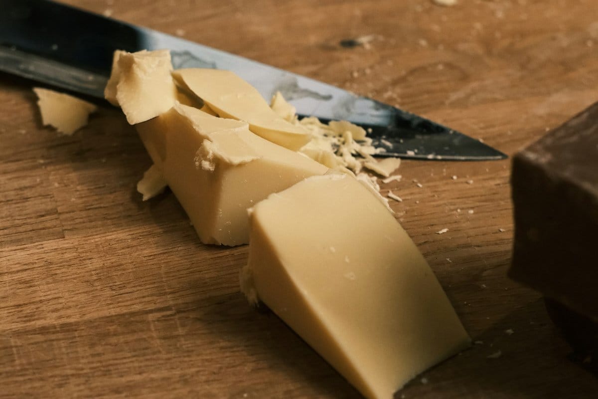 Cutting Happy Cow processed white cheese into cubes for Belizean cheese dip