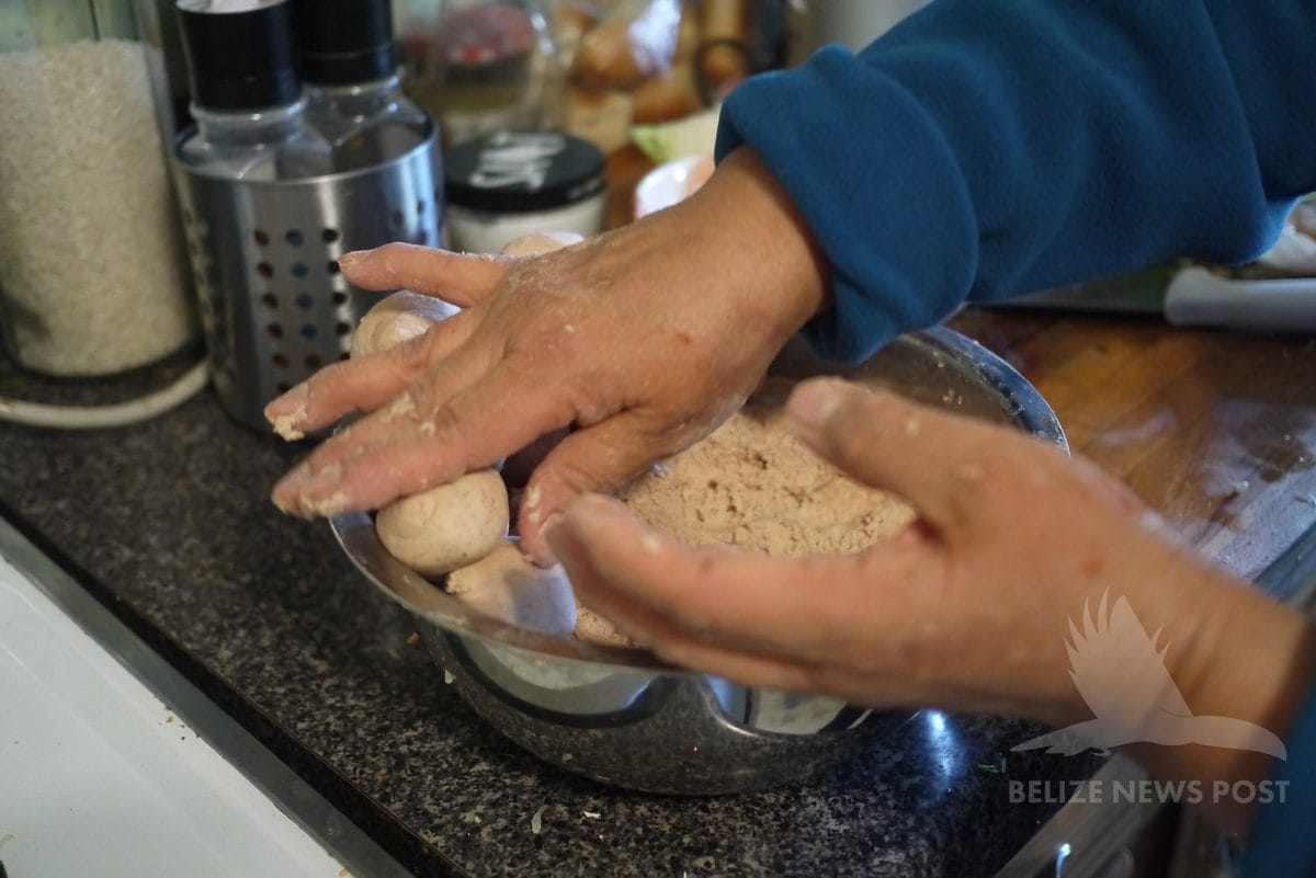 Hands rolling corn masa dough into a ball for joroches