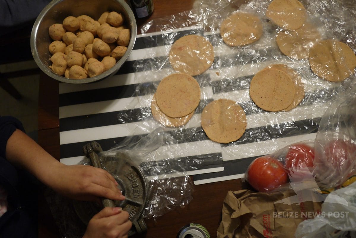 Pressed achiote masa rounds and masa balls ready for mukbipollo assembly with tortilla press