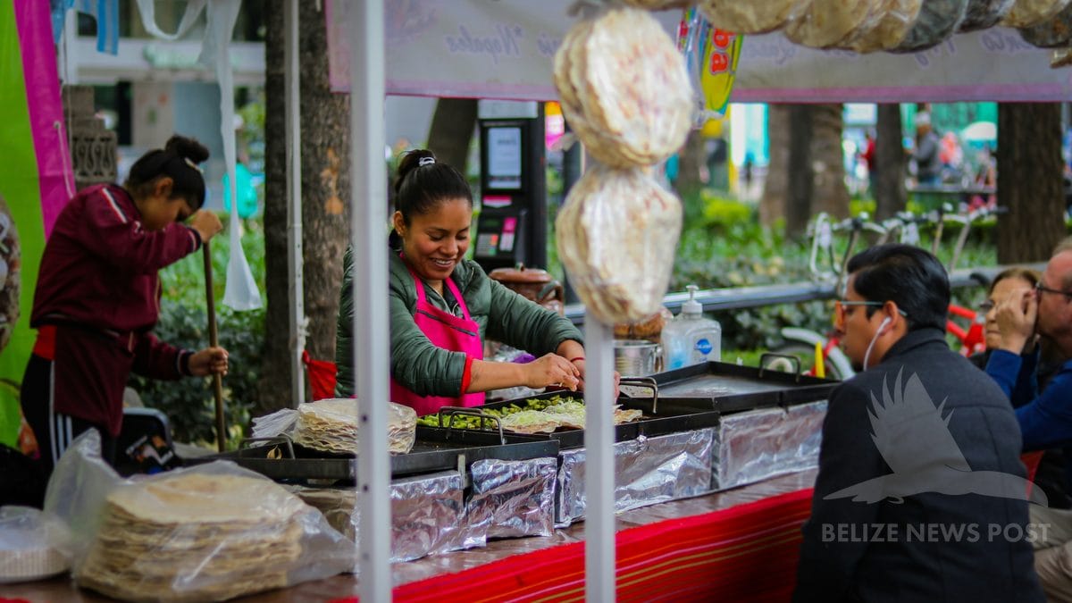 Yucatan market food vendor preparing tortillas and tamal dishes