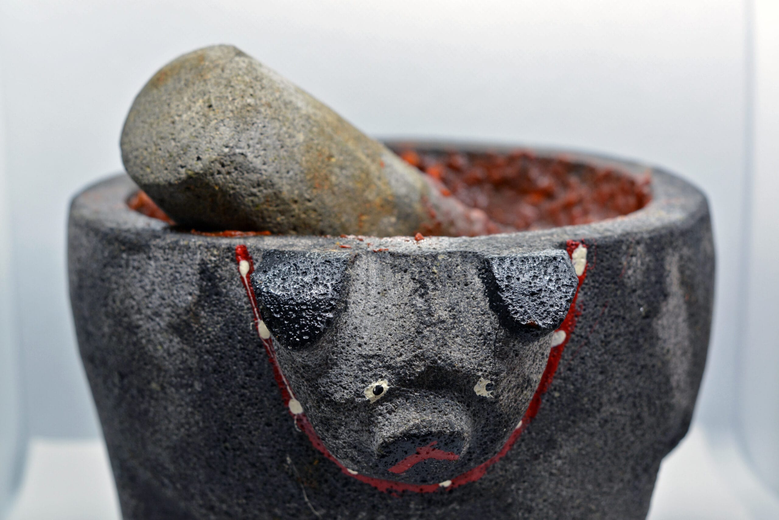 A stone molcajete with red salsa, a traditional Mexican kitchen tool