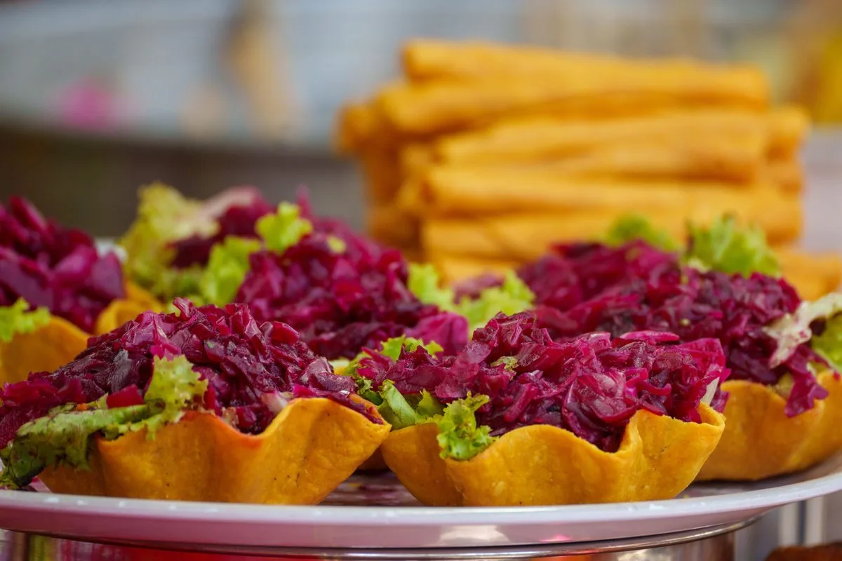 Fried tortilla cups filled with pickled beet curtido, a Guatemalan antojito