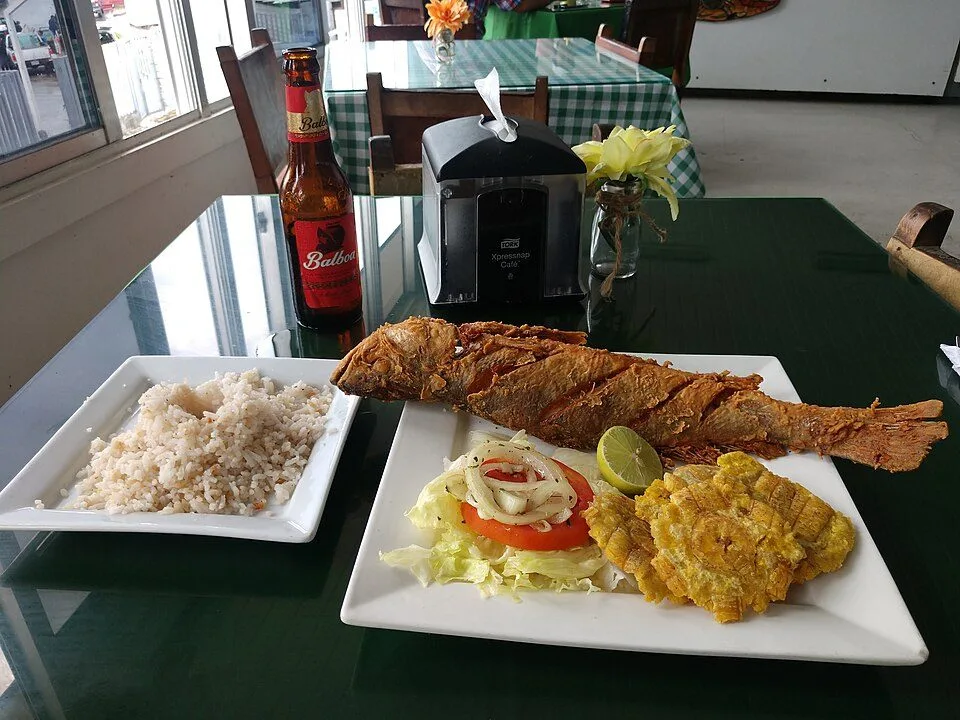 Whole fried fish with coconut rice and patacones, Caribbean-coast style