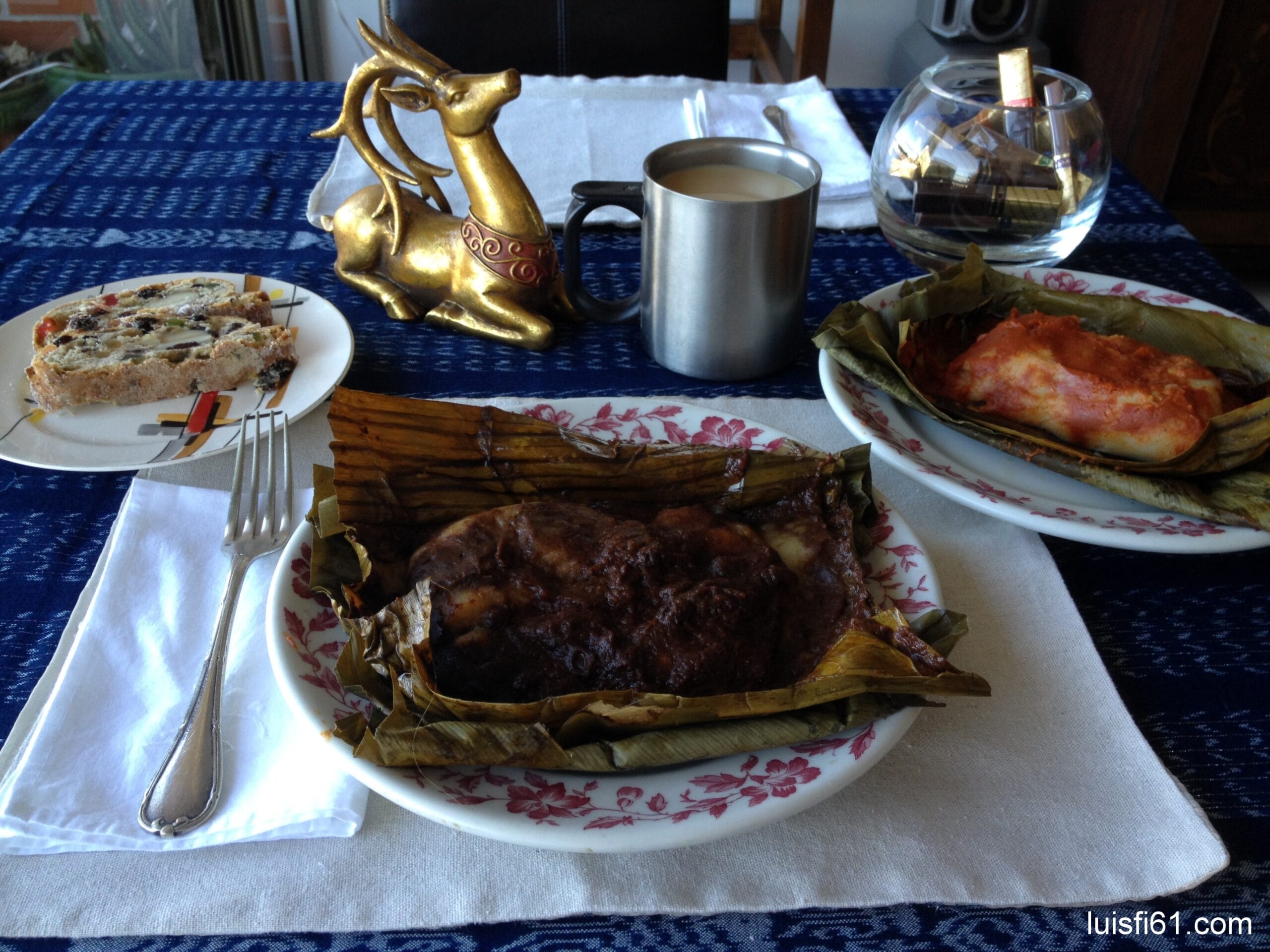 Guatemalan tamales negros and colorados wrapped in banana leaf on a plate for Christmas