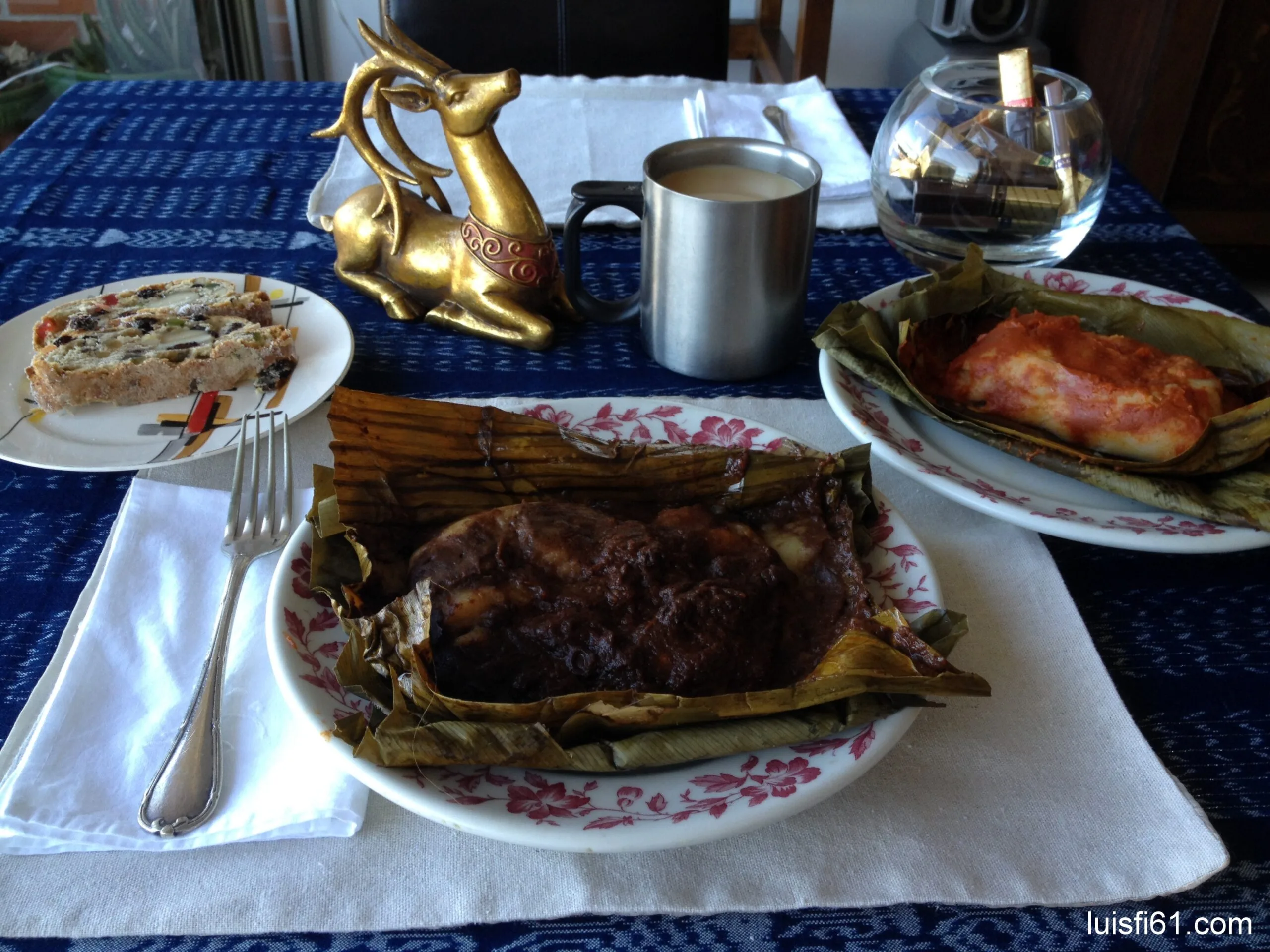 Guatemalan tamales negros and colorados wrapped in banana leaf on a plate for Christmas