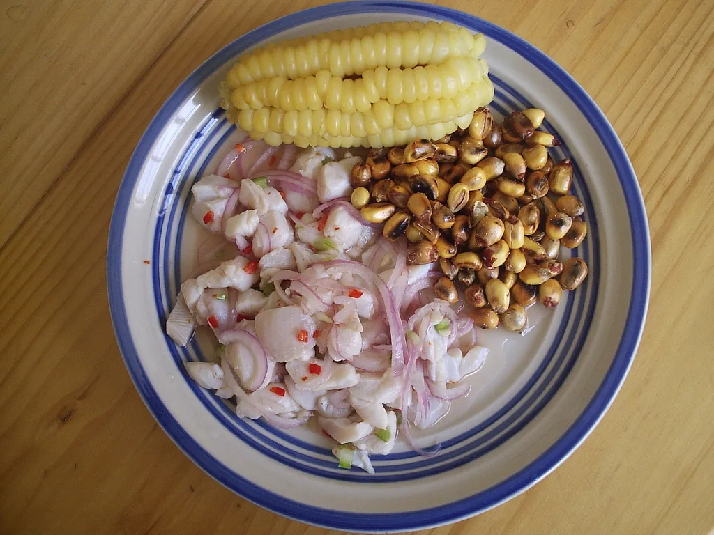 Bowl of shrimp ceviche with lime juice, red onion, tomato and cilantro