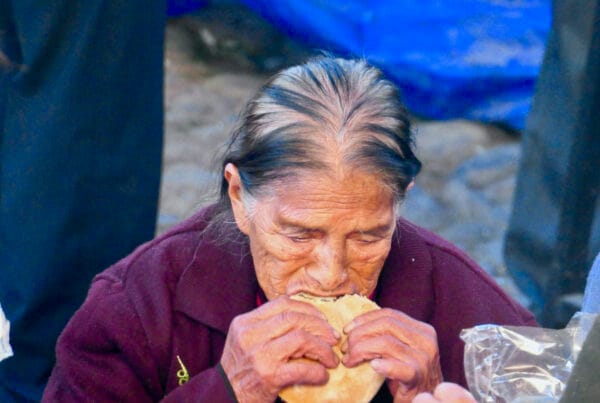 Vendors at Chichicastenango market in Guatemala, with traditional food items on display