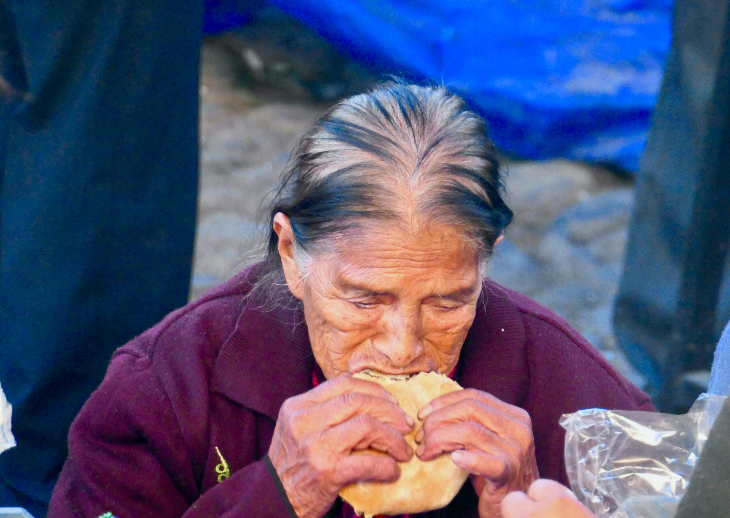 Vendors at Chichicastenango market in Guatemala, with traditional food items on display