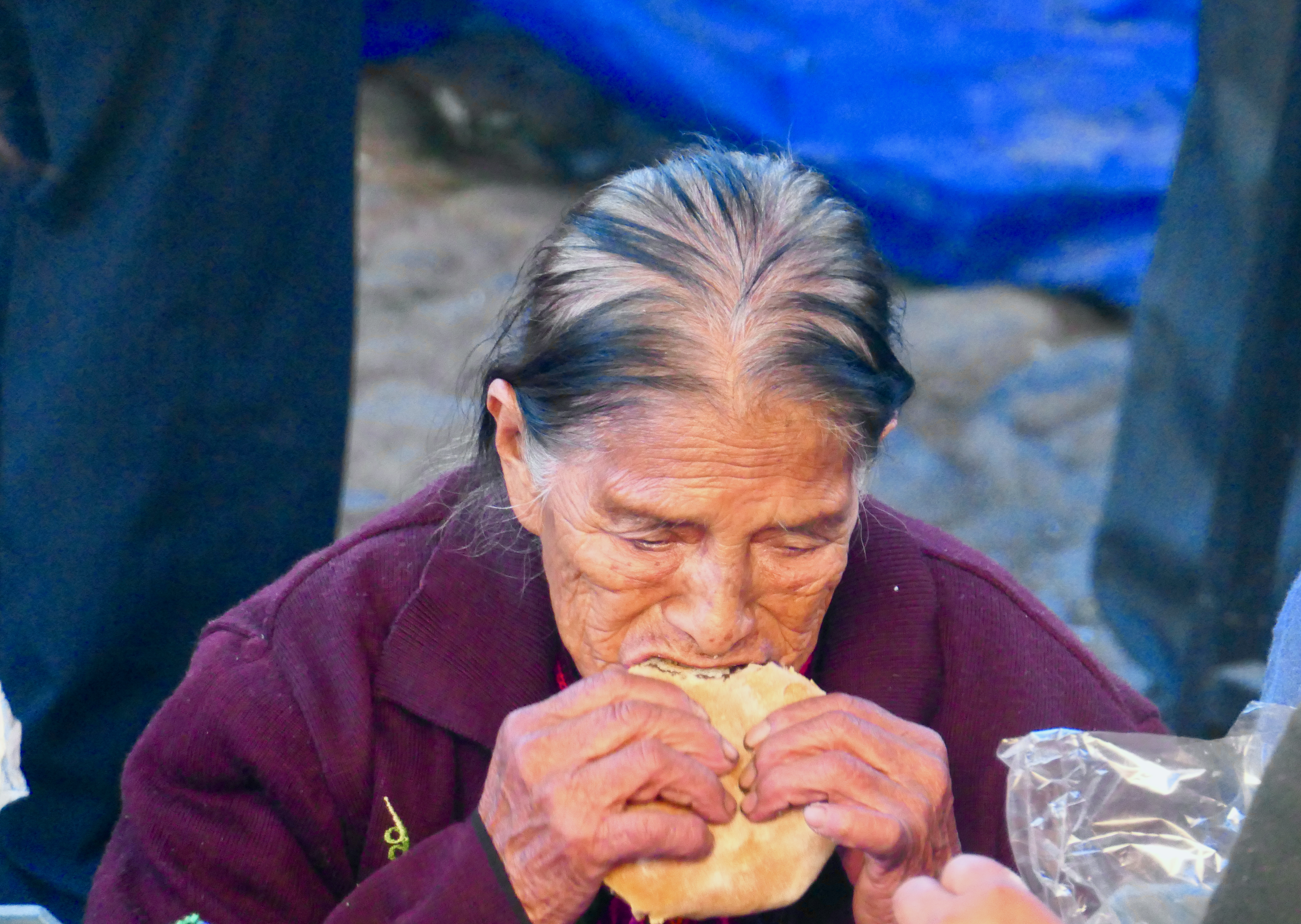 Vendors at Chichicastenango market in Guatemala, with traditional food items on display