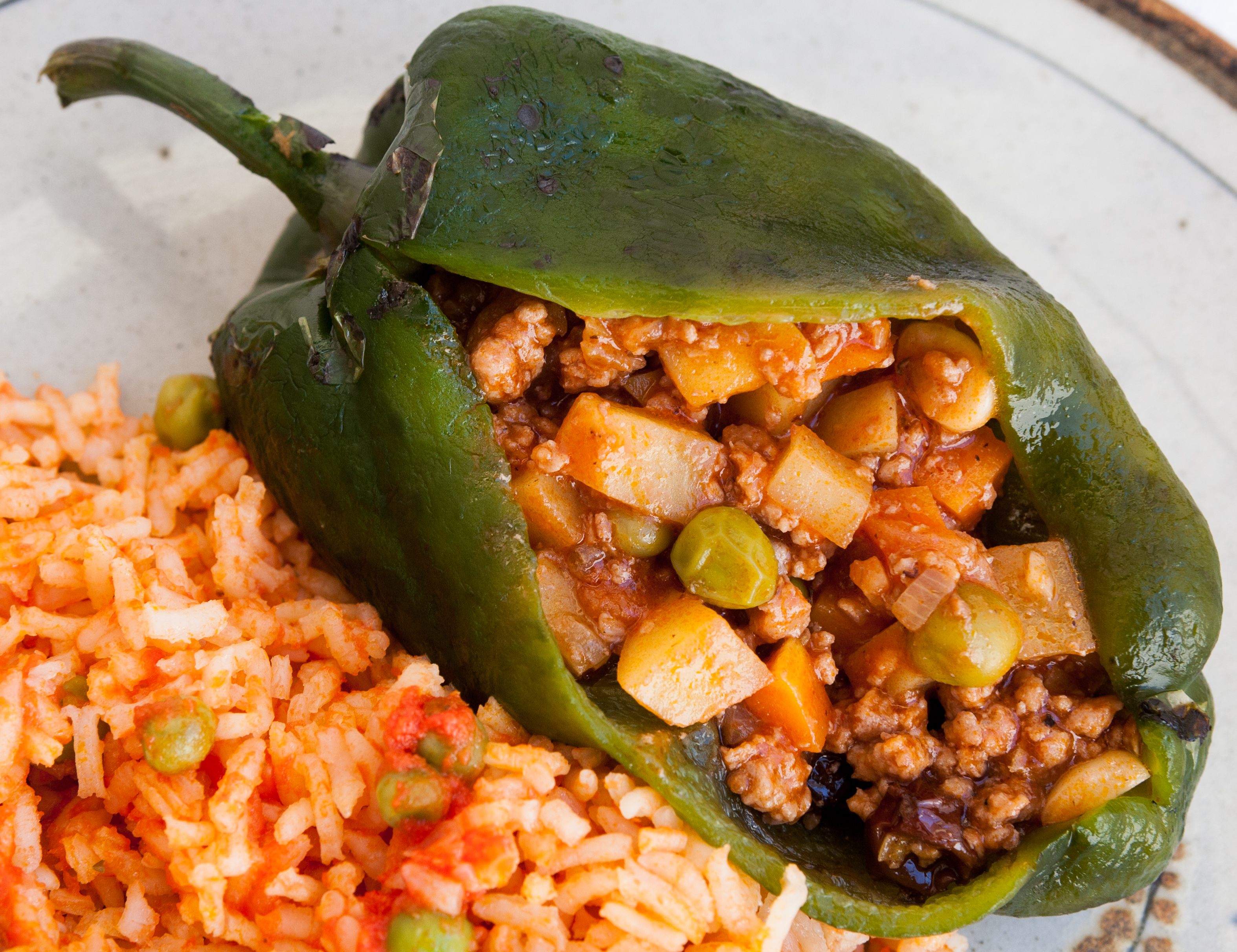 Guatemalan chiles rellenos: a battered, fried stuffed bell pepper served with tomato sauce