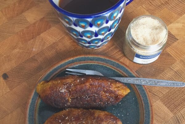 Salvadoran empanadas de platano fried golden and rolled in sugar on a plate