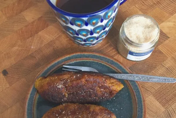 Salvadoran empanadas de platano fried golden and rolled in sugar on a plate