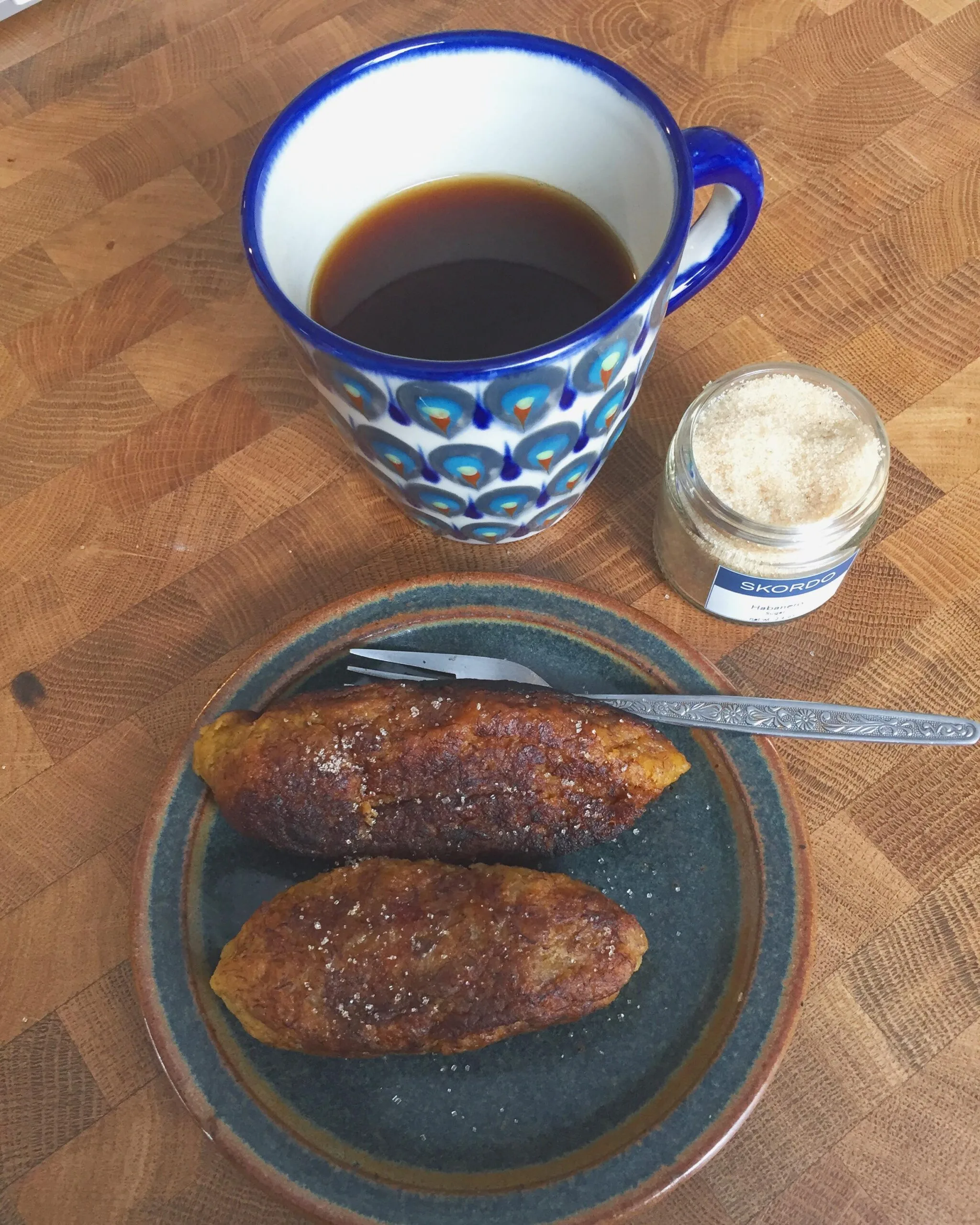 Salvadoran empanadas de platano fried golden and rolled in sugar on a plate