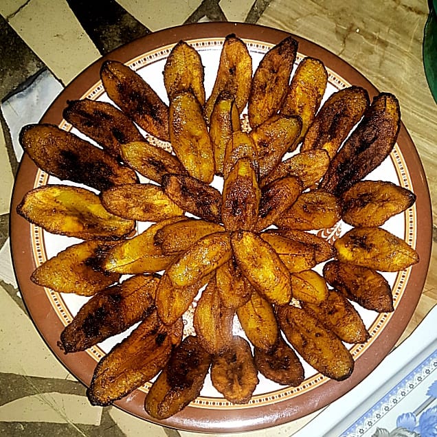 Very ripe plantains frying in oil until caramelized