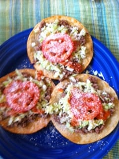 Honduran enchiladas: a crispy fried corn tortilla topped with beef, cabbage, egg, and queso seco