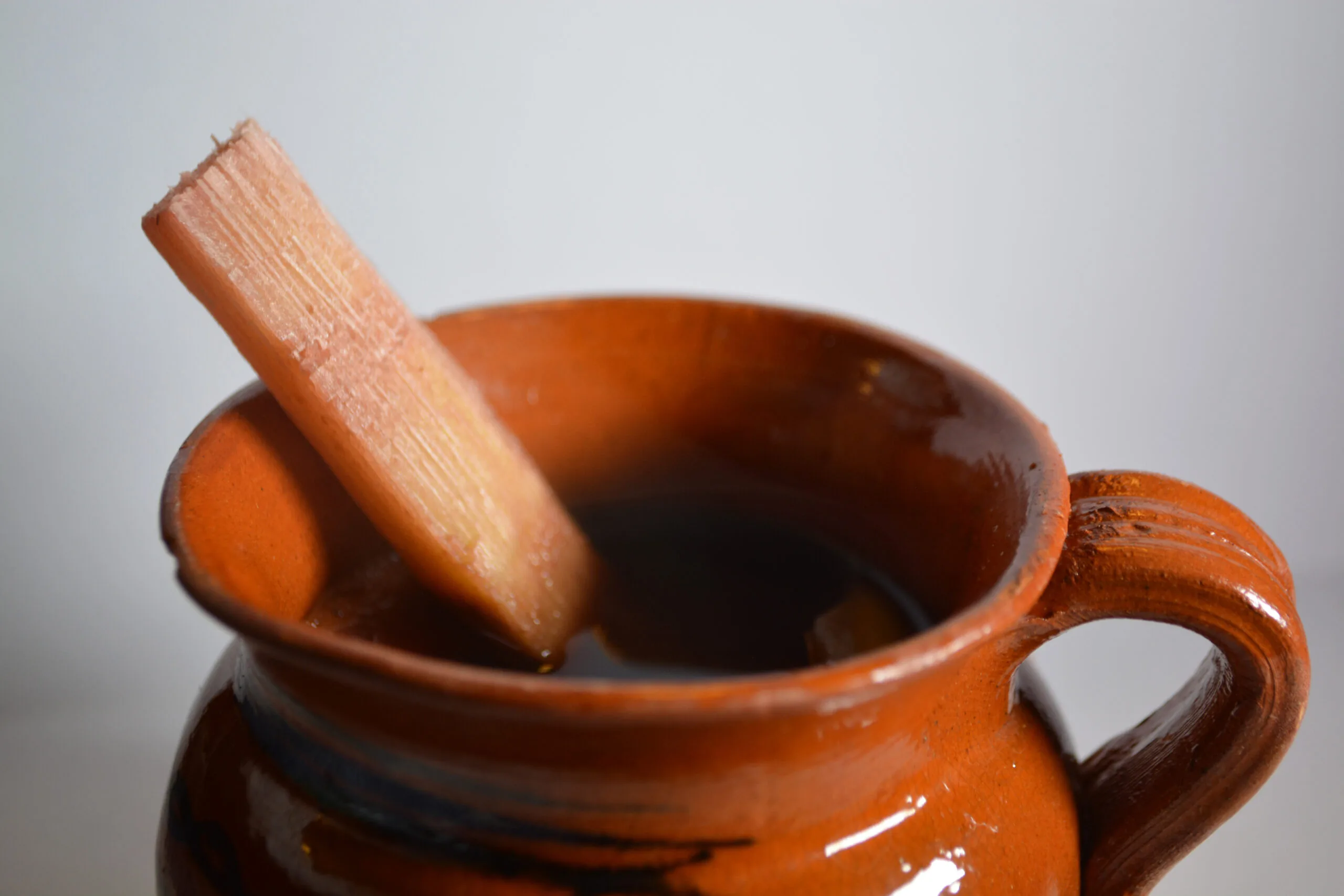 Steaming cup of ponche guatemalteco — hot Guatemalan Christmas fruit punch with cinnamon sticks and dried fruits