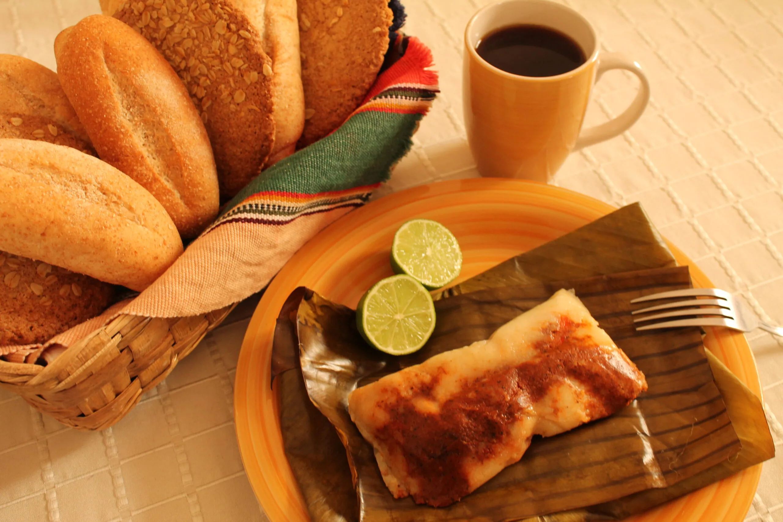 Guatemalan tamales colorados, the red-recado tamal served with bread and coffee