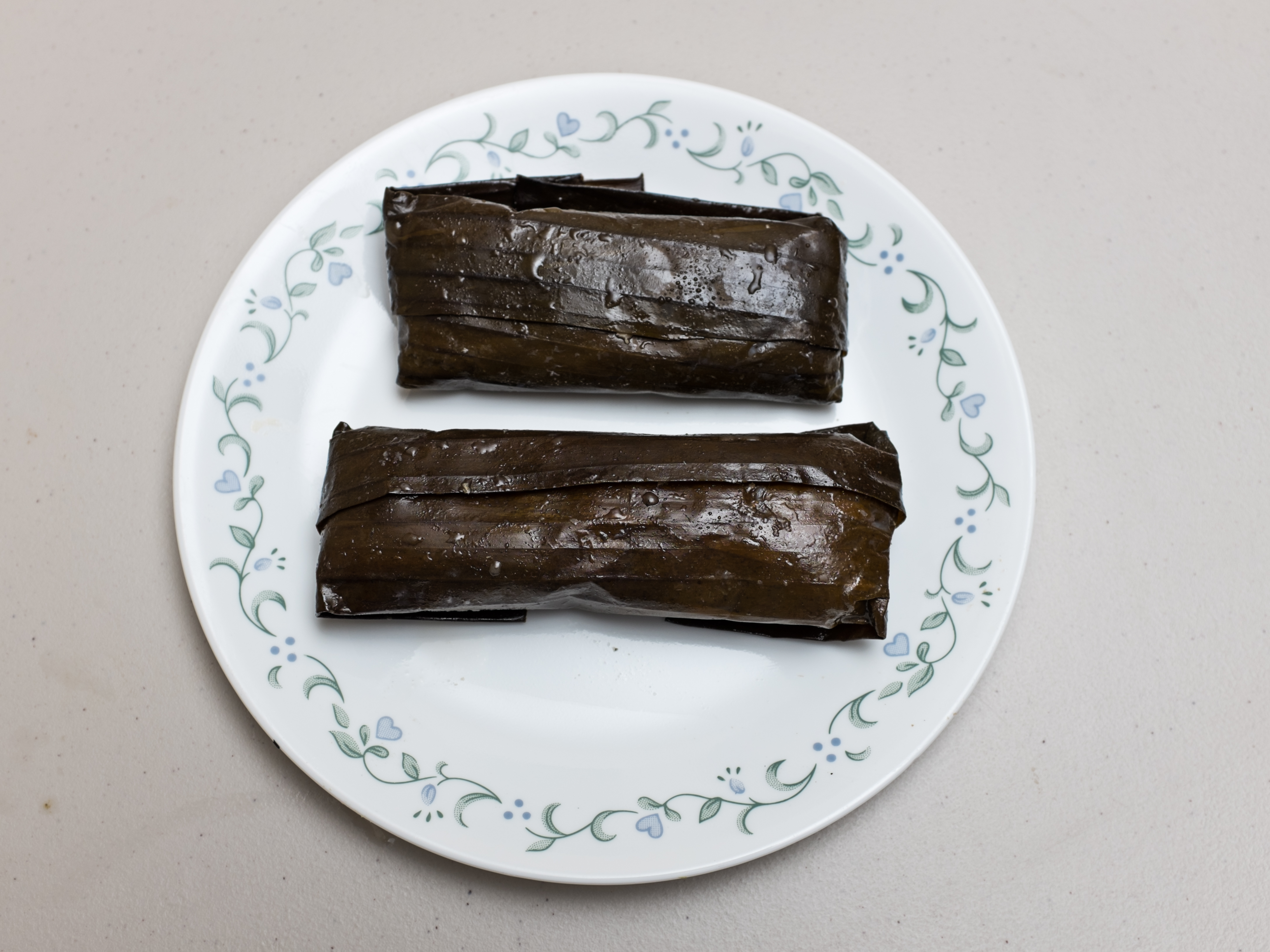 Tamales pisques wrapped in banana leaves — Salvadoran bean-masa tamales, a Pipil/mestizo Lenten staple