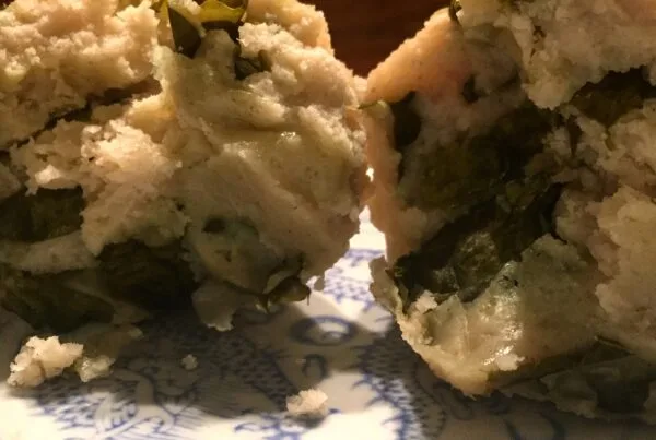 Boxboles — Q'eqchi' Maya corn masa rolls with chipilín, served with toasted pepita sauce and crumbled white cheese