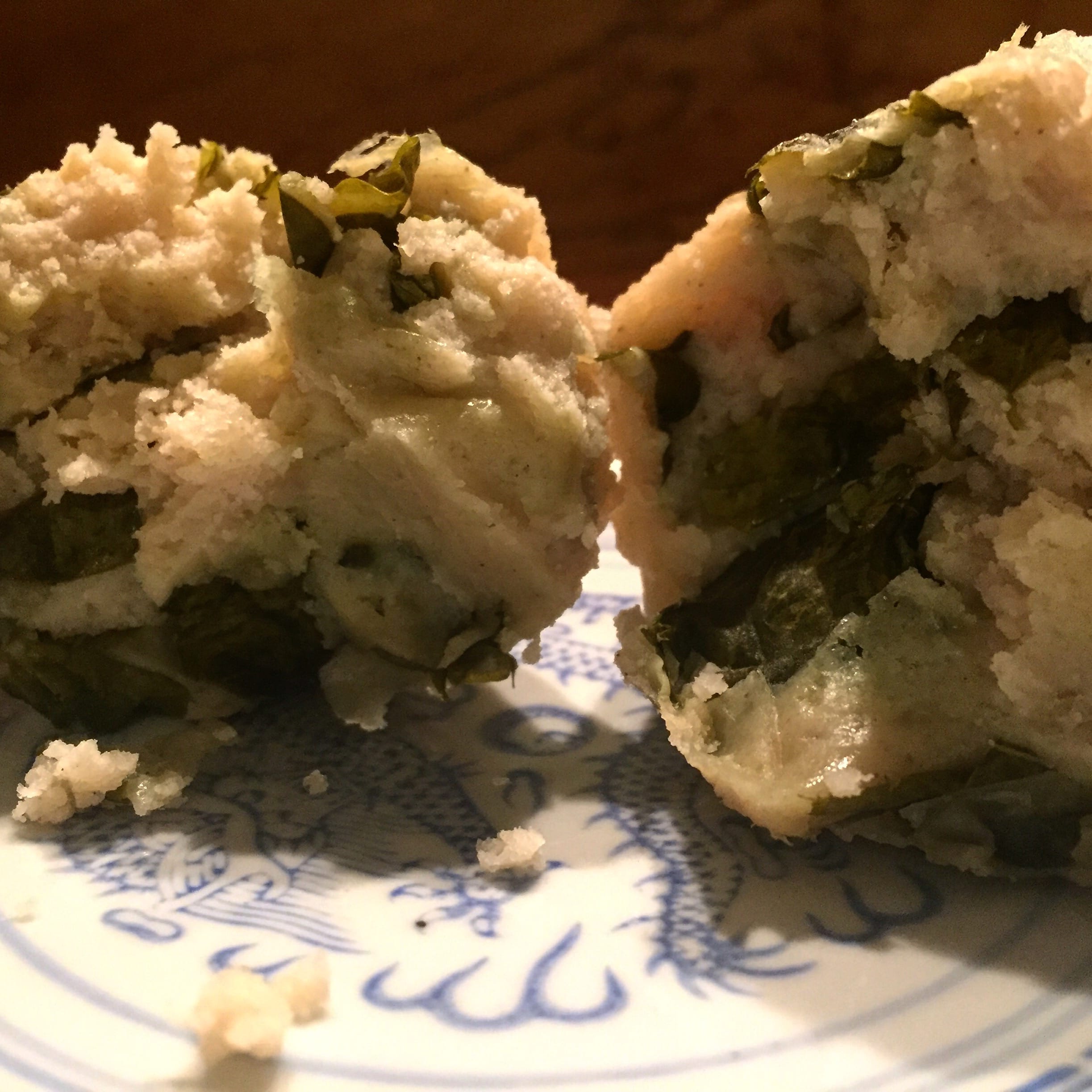 Boxboles — Q'eqchi' Maya corn masa rolls with chipilín, served with toasted pepita sauce and crumbled white cheese