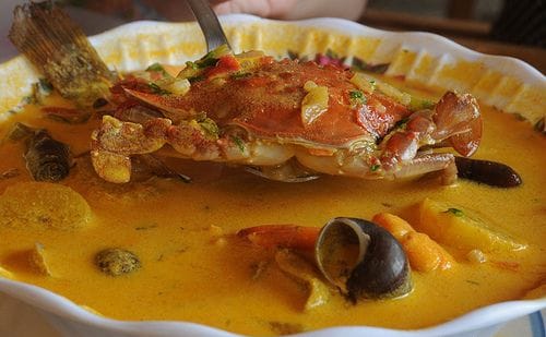 Bowl of tapado, the Garifuna coconut seafood stew of the Honduran coast, with fish, plantain, and yuca