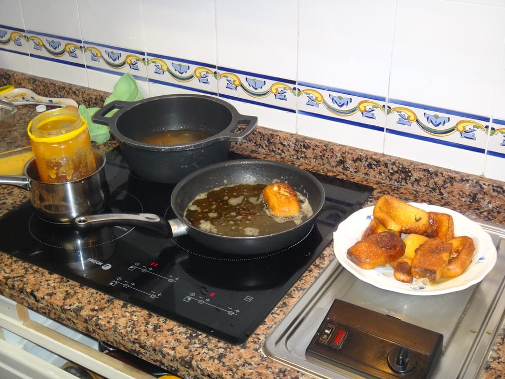 Fried sweet bread rolls steeped in syrup, showing the egg-dipped-and-fried technique central to molletes guatemaltecos