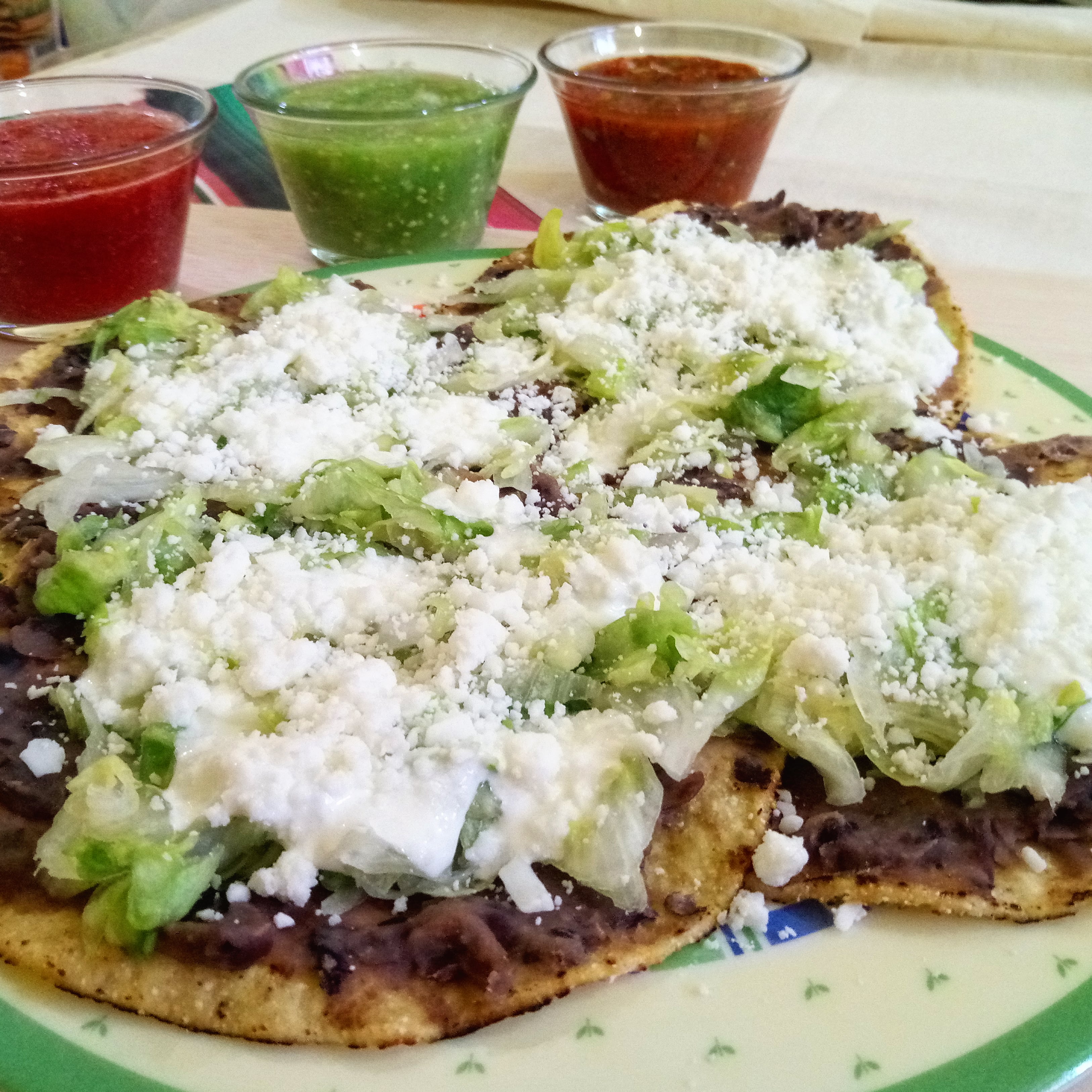 Honduran bean tostadas: crisp fried corn tortillas topped with refried beans and crumbled queso fresco