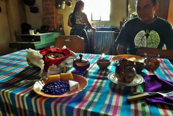 Traditional Guatemalan breakfast plate with frijoles volteados, fried eggs, plantains, tortillas, and crema - San Juan la Laguna, Guatemala