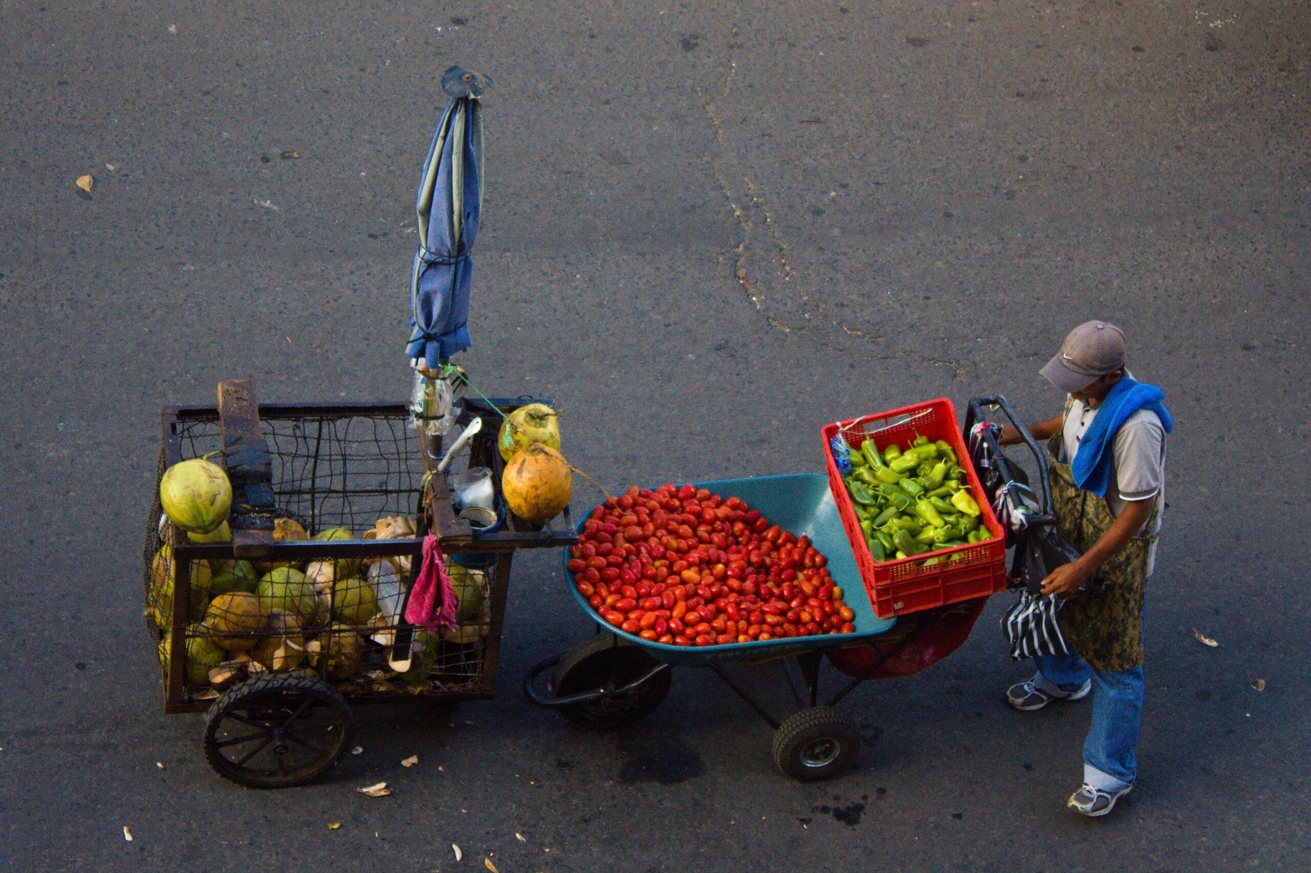 A street vendor selling food from a cart in San Salvador, El Salvador
