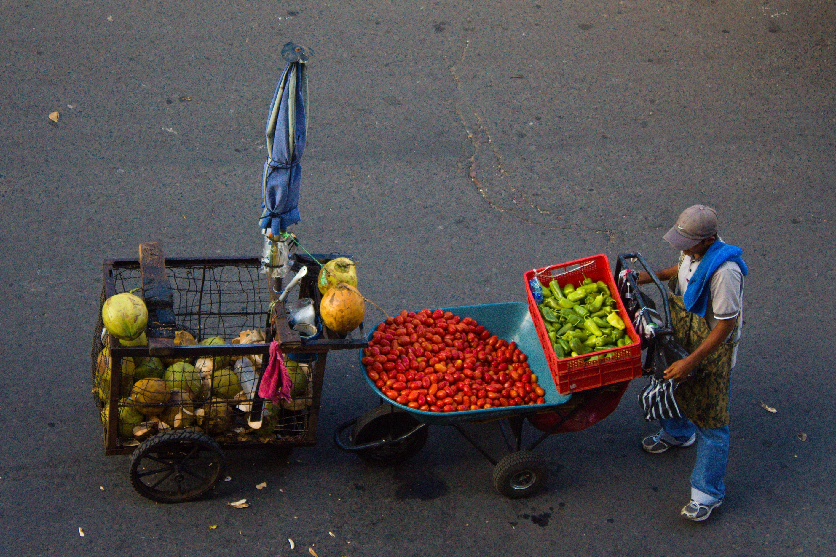 A street vendor selling food from a cart in San Salvador, El Salvador