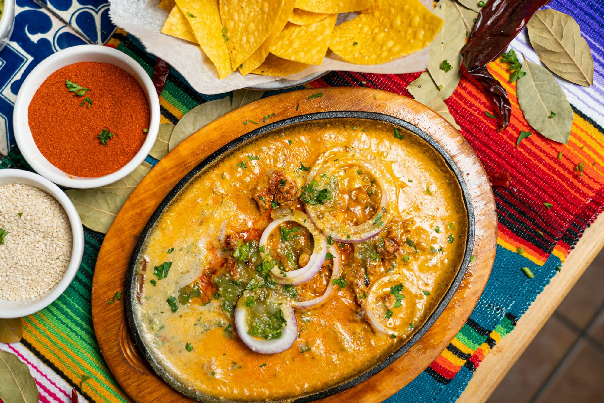 Anafre, the Honduran hot refried red bean and melted cheese dip, served bubbling in a clay brazier with crisp totopos
