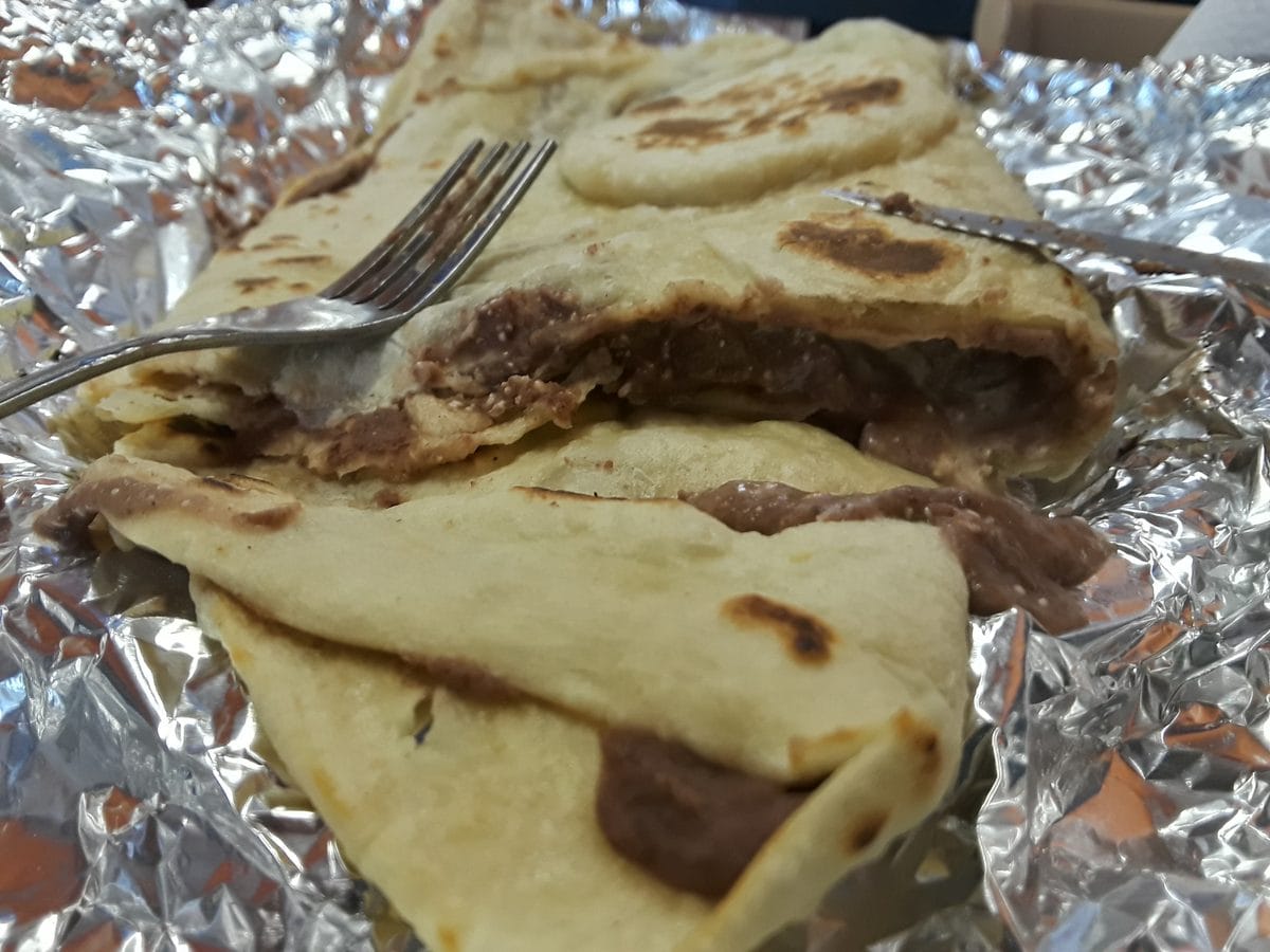 Cross-section of a Honduran baleada with beans, cream and cheese