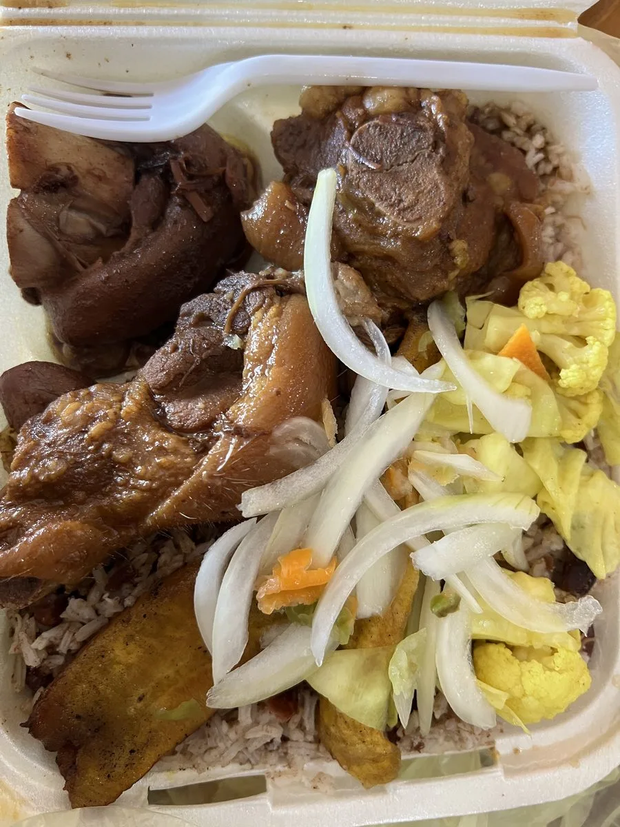 Belizean stew cow foot and pigtail over rice and beans with fried plantain and pickled slaw