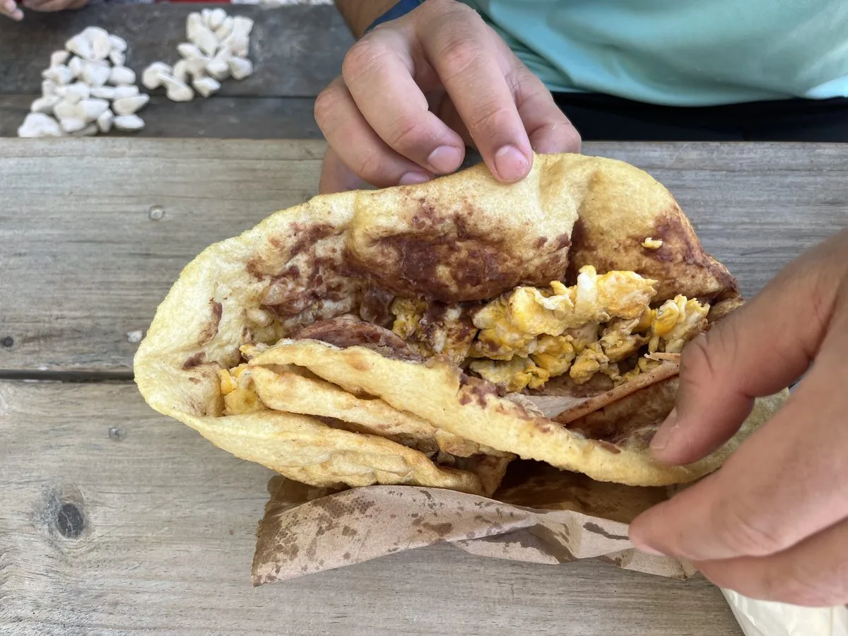 Belizean fry jack stuffed with egg and ham for breakfast