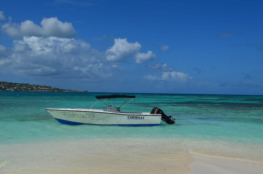 A small boat moored on a turquoise Caribbean shore