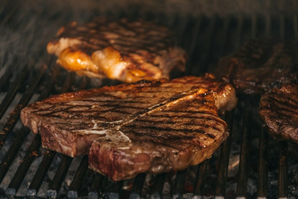 Honduran carne asada thin marinated beef grilling over charcoal