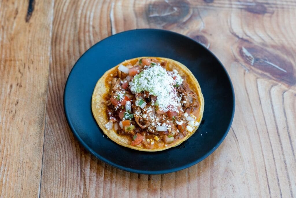 Shredded meat piled on a crisp tostada, the way tsik de venado is served