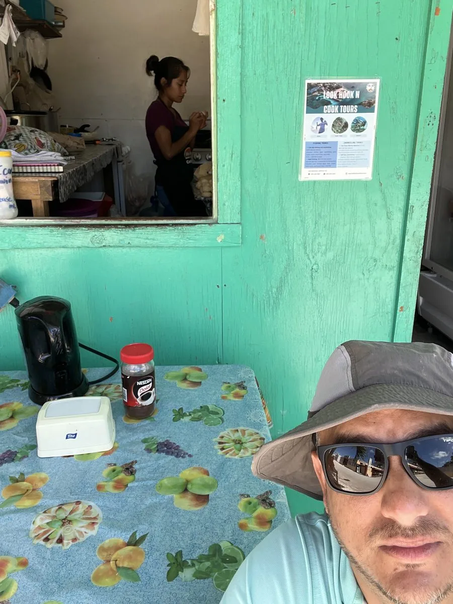 Sitting down to eat at a small Belizean food stand with fresh tortillas being made