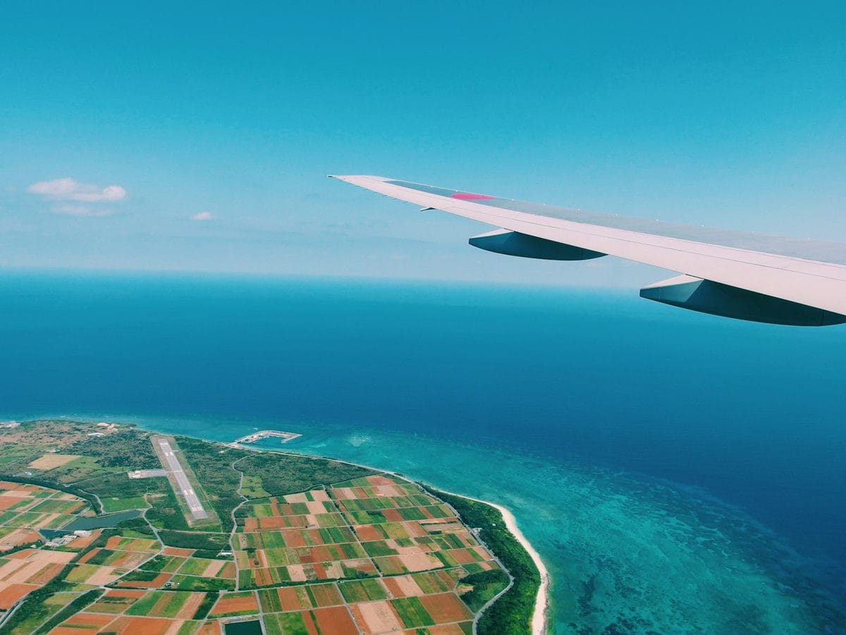 View of a turquoise Caribbean coastline from an airplane window