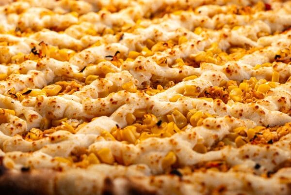 Golden baked corn and cheese cookie like a Honduran tustaca, served as a sweet coffee-time treat