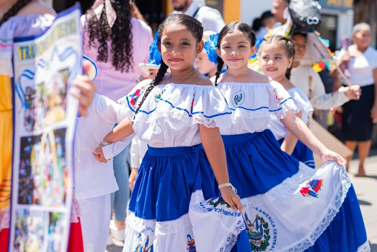 Honduran girls in traditional blue-and-white folk dress at a festival