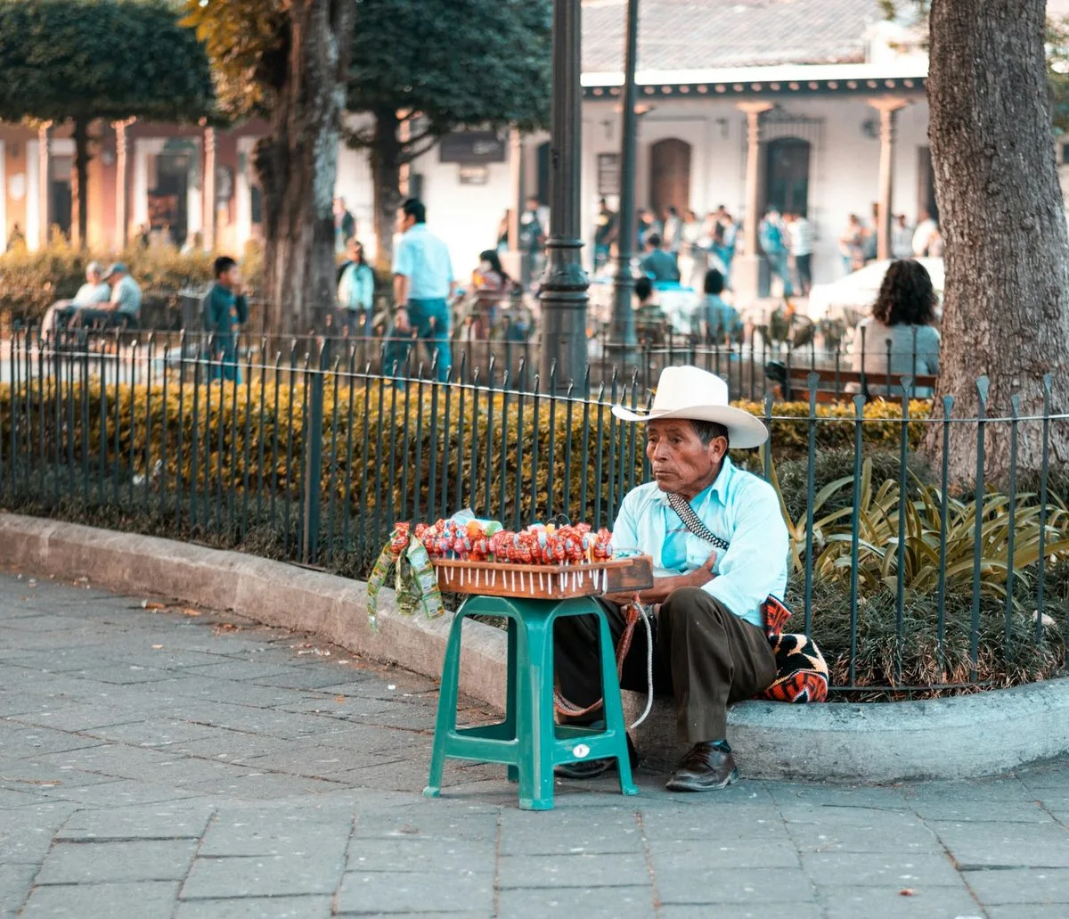 A street vendor selling fruit in a Central American town square